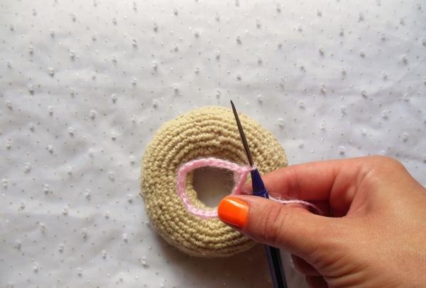 Crochet pincushion in the shape of a donut