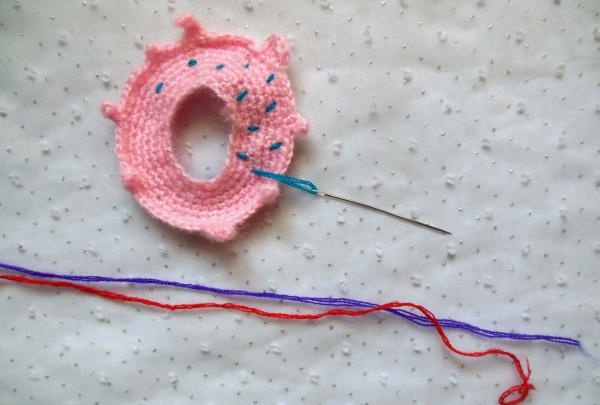 Crochet pincushion in the shape of a donut