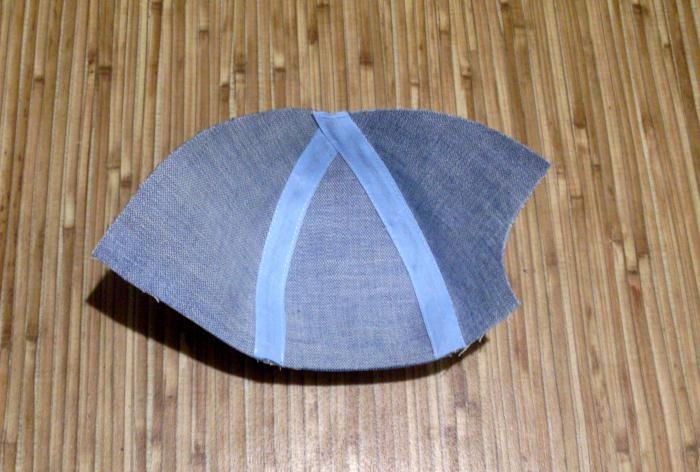 We sew a denim baseball cap for a baby