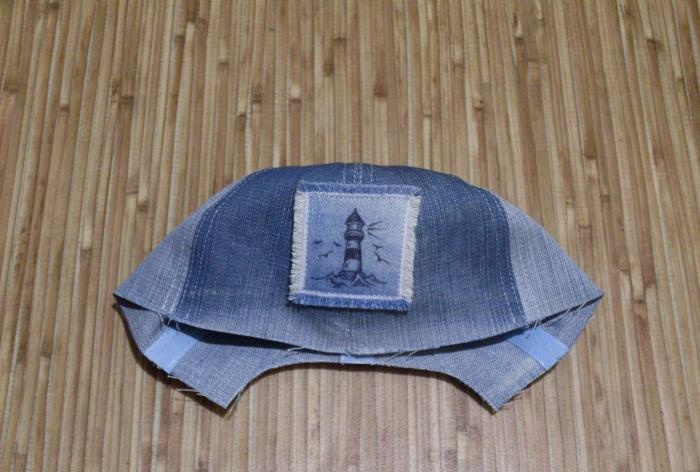 We sew a denim baseball cap for a baby