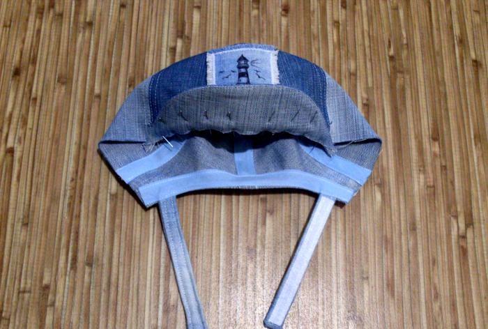 We sew a denim baseball cap for a baby