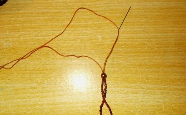 string beads or seed beads onto a thread