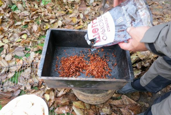 Place wood chips on the bottom of the smokehouse