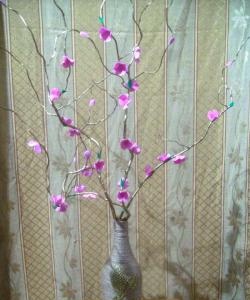 Vase with flowers on a branch