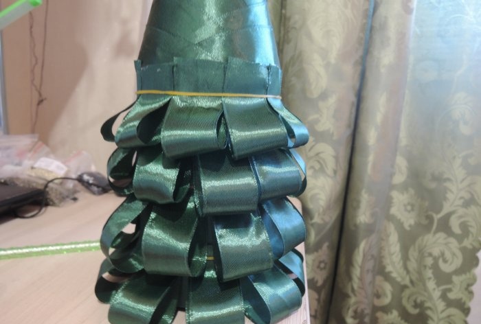 Champagne dressed up as a Christmas tree for the New Year's table