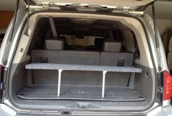 Convenient folding shelf in the trunk of a car