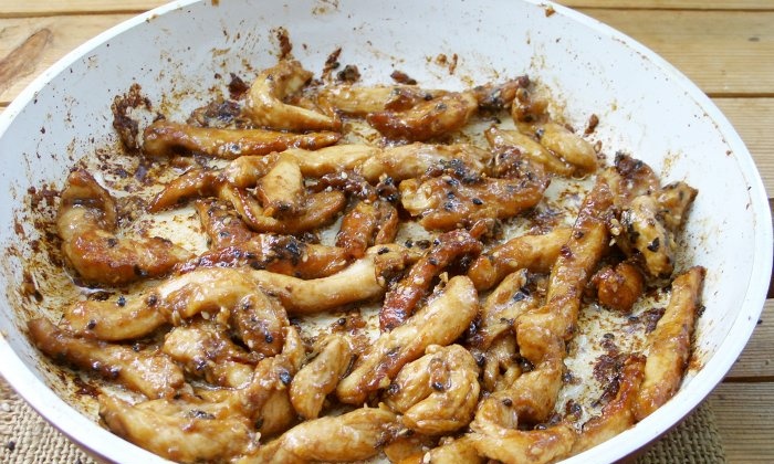 Chicken fillet in soy sauce in a frying pan