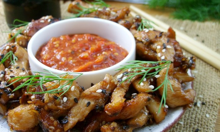 Chicken fillet in soy sauce in a frying pan