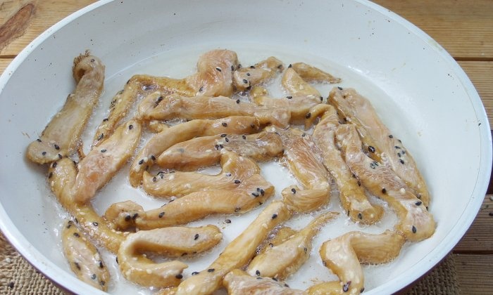 Chicken fillet in soy sauce in a frying pan