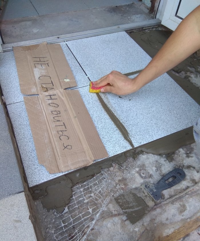 Removing old tiles and laying new tiles on threshold steps