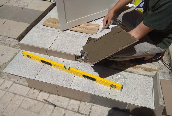 Removing old tiles and laying new tiles on threshold steps