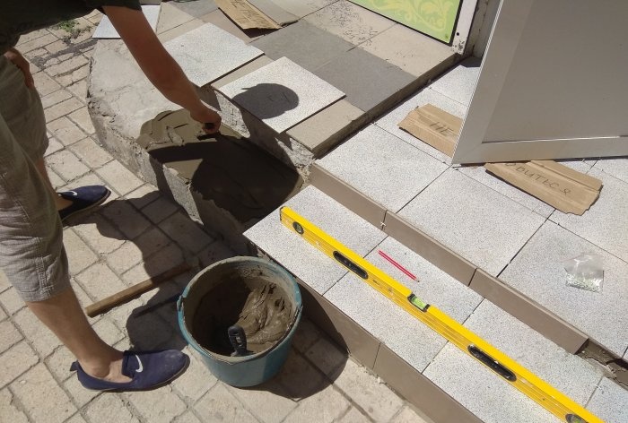 Removing old tiles and laying new tiles on threshold steps