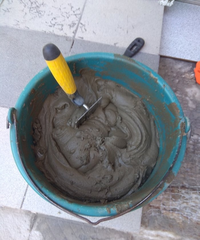 Removing old tiles and laying new tiles on threshold steps