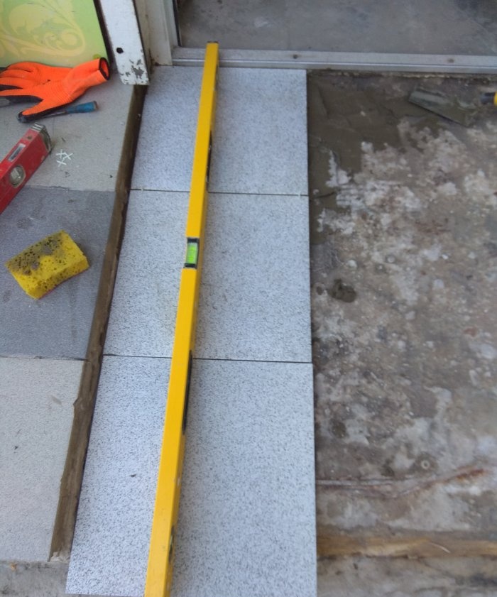 Removing old tiles and laying new tiles on threshold steps