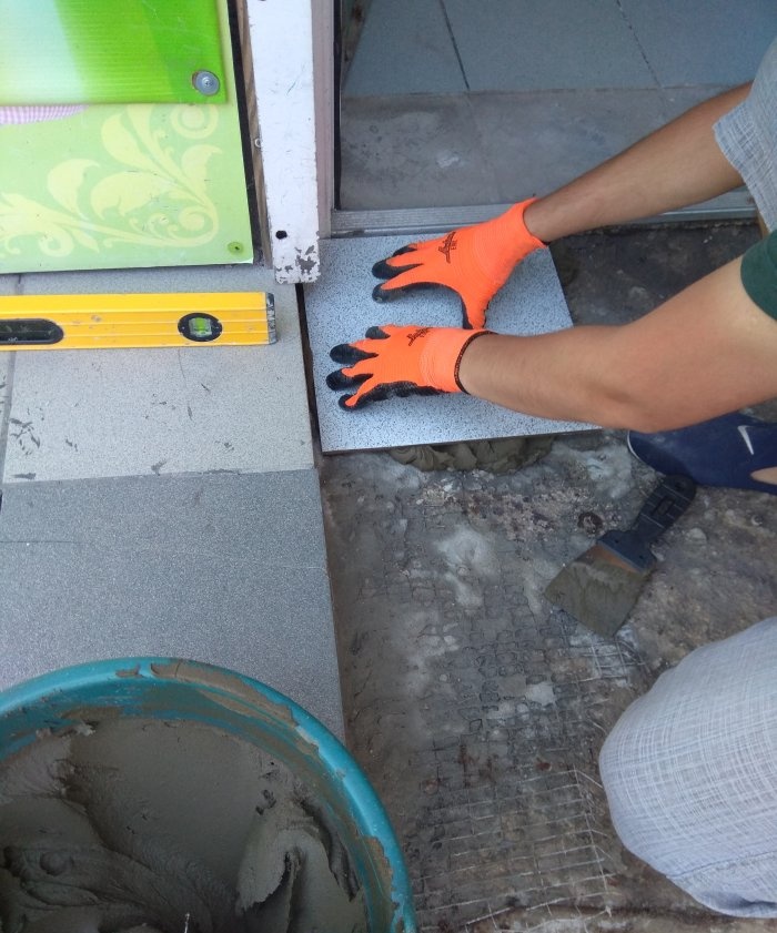 Removing old tiles and laying new tiles on threshold steps