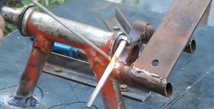 A simple stand for an angle grinder made from a bicycle