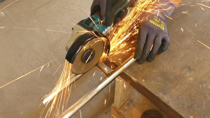 Stand for an angle grinder made from the handle of a children's bicycle