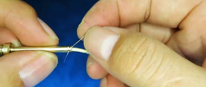 bring out through a cut in the thread