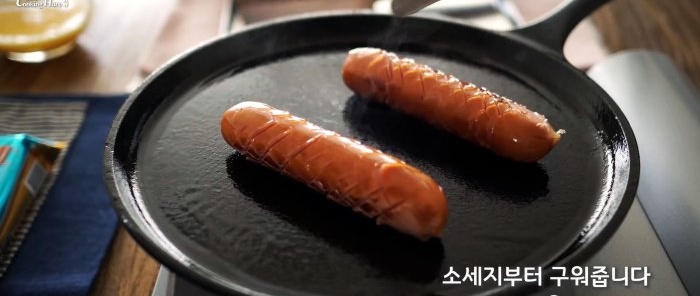 Sausages frying on a frying pan