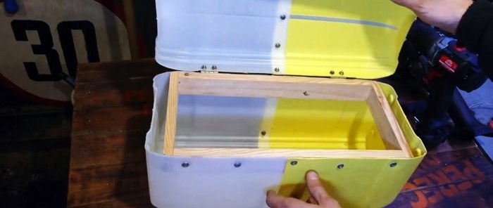 A large tool box made from plastic canisters is almost ready