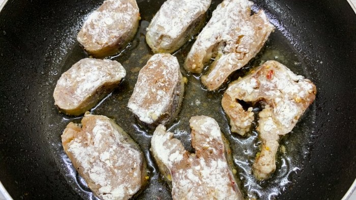 Fry pollock in boiling oil