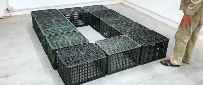 Bed made of plastic vegetable crates with numerous storage spaces