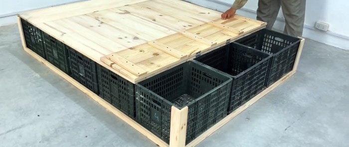 Bed made of plastic vegetable crates with numerous storage spaces